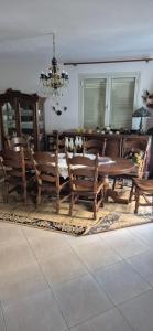 a dining room with a wooden table and chairs at Ela apartament in Golem