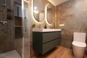 a bathroom with a sink and a toilet and a mirror at LOFT Accommodative A in Valencia +14 photos
