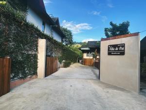 a driveway with a sign on the side of a building at Villa De Pai in Pai