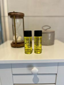 two bottles of oil sitting on top of a counter at Charmant studio à 10 min de Lyon in Miribel +9 photos