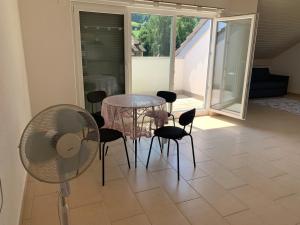 a dining room with a glass table and chairs at Homely 2,5 room apartment in Safenwil