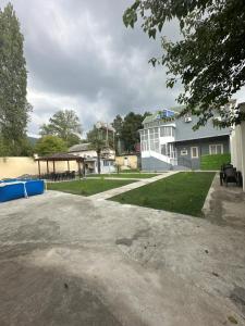 a large white building with a gazebo at Sheki GuestHouse in Sheki +12 photos