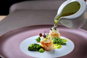 a plate with food and a cup of coffee at Mount Med Resort in Oberau