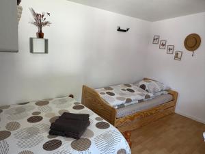 a bedroom with two beds in a room at Nuit insolite au cœur d’un ranch proche d’Europa park in Schwobsheim