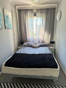 a bedroom with a large bed with a window at FjordNest Årdalstangen with sauna in Årdalstangen