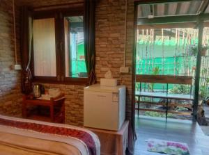 a room with a bed and a large window at Goodluck village house in Ko Mook