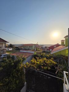 a view of a city from a balcony with flowers at Casa frente al mar in Valdoviño