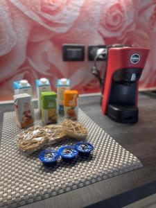 a counter with a coffee maker and some food at B&B Le Peonie Alloggio centrale vicino al mare in Ravenna