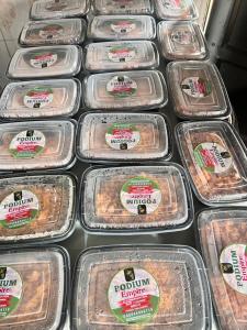 a display of plastic containers of food in a store at Podium Empire in Lekki