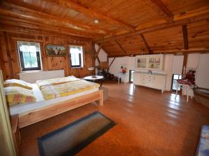 a bedroom with a bed in a room with wooden ceilings at Home with Garden & BBQ in Všelibice +24 photos