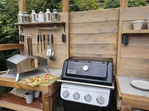 a grill and a pizza on a wooden table at Riverwood Lodge in Montriond +19 photos