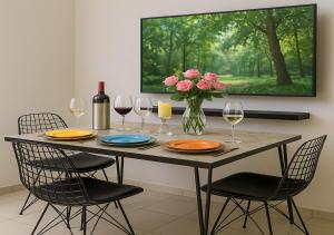 a table with wine glasses and a vase of flowers at 34 Yüksel Garden in Ankara
