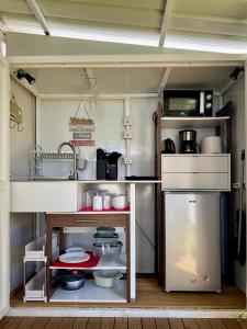a small kitchen with a sink and a stove at Tikaban in Pointe d'Esny