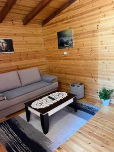 a living room with a couch and a coffee table at Bujtina Uji I Panjes, LLOGARA in Vlorë