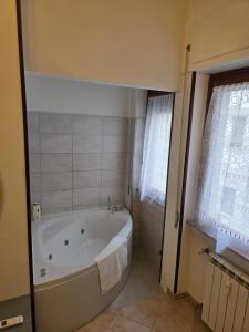 a bathroom with a bath tub in a room at Alloggio turistico di Stefano in Lido di Ostia