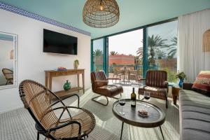 a living room with a couch and chairs and a table at U Splash Resort Eilat in Eilat