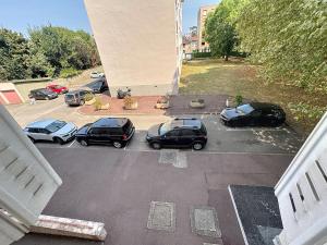 a group of cars parked in a parking lot at Le Cosy Genin - 3 Chambres Bureaux Parking in Lyon