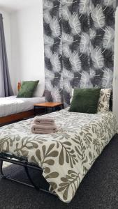 a bed in a room with a wall at House 36 in Liverpool