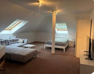 a living room with a couch and a bed and a tv at Ferien oder Monteurzimmer in Ibbenbüren