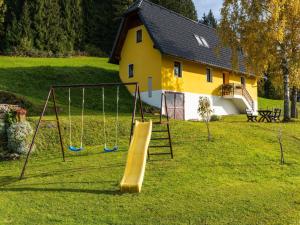 a playground with a slide in front of a house at Chalet in Eberstein nahe Saualpe Skigebiet in Eberstein