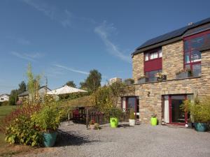 a brick house with potted plants in front of it at Cozy Nature Escape, Stoumont in Stoumont +32 photos