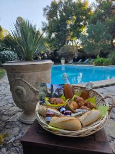 - un panier de nourriture sur une table à côté de la piscine dans l'établissement Appartement familial à Arles avec jardin et piscine, à Arles