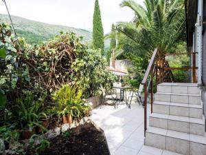 a patio with stairs and a table and some plants at Dubrovnik Coastal Gem in Dubrovnik