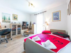 a bedroom with a large bed with a red blanket at Dubrovnik Coastal Gem in Dubrovnik