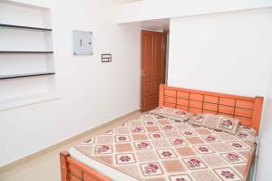 a bedroom with a bed in a room at KHS Lakshmi-U in Ambāsamudram