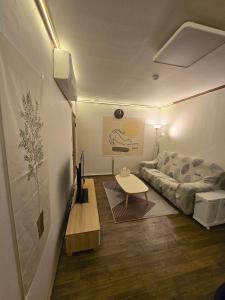 a living room with a couch and a table at Cozy house in Seoul +7 photos