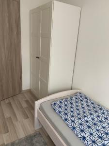 a bedroom with a bed and a closet at Ferienwohnung Kranichblick in Kargow +5 photos