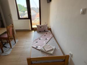 a room with a bed with a pillow on it at Rooms Stefan 2 in Subotica +65 photos