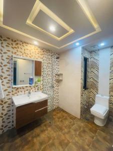 a bathroom with a sink and a toilet at Cozy&Peaceful Apartment in Lahore
