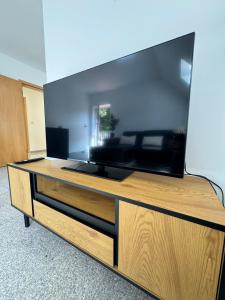 a large entertainment center with a large flat screen tv at Geräumig wohnen, stilvoll genießen in Soltau
