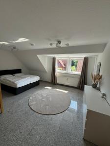 a bedroom with a bed and a table and a window at Geräumig wohnen, stilvoll genießen in Soltau +16 photos