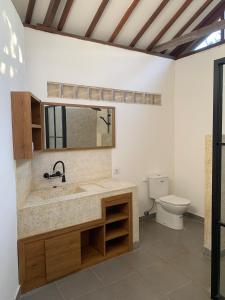 a bathroom with a sink and a toilet at Lullaby Bungalows in Uluwatu +31 photos