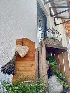 a heart on the side of a building with a broom at Ferienhaus K 39 a - Chiemgau Karte in Inzell +33 photos