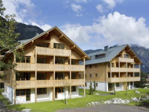 a large apartment building with mountains in the background at Chalet in Brand nahe Skilift & Pisten in Brand