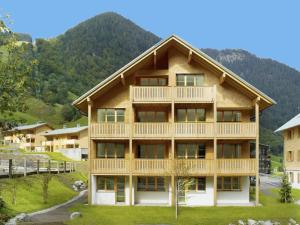 a large wooden building with a mountain in the background at Chalet in Brand nahe Skilift & Pisten in Brand