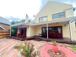 a house with a brick patio in front of it at Petalsoft in Pretoria +2 photos