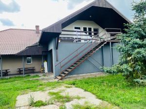 a building with a staircase on the side of it at Borowikowa Knieja in Brody