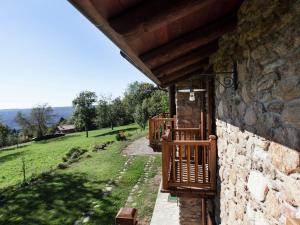 a stone house with a porch and a stone wall at Apartment in Netro with Balcony and Views in Netro