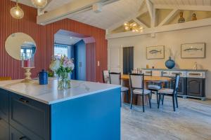 a kitchen and dining room with a table and chairs at Villa Les Bains de Mer avec spa in Saint-Gilles-Croix-de-Vie