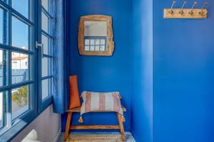 a blue room with a chair and a mirror at Villa Les Bains de Mer avec spa in Saint-Gilles-Croix-de-Vie