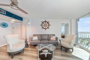 a living room with a couch and chairs and a table at On the Beach-2/Br 2/Bath, 26th floor! Spectacular views of Ocean & River in Daytona Beach Shores