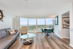 a living room with a couch and a table at On the Beach-2/Br 2/Bath, 26th floor! Spectacular views of Ocean & River in Daytona Beach Shores