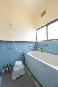 a bathroom with a toilet and a bath tub at Private 1K Flat with 2 Single beds and sofa-bed, Near Tokyo & Quiet Area, 202 in Tokorozawa