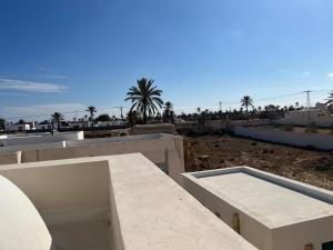 a view from the roof of a building with palm trees at Traditional home in Temlale