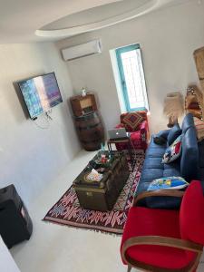 a living room with a couch and a table at Traditional home in Temlale