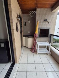 a bathroom with a sink and a towel on the wall at Caioba Apto Confortavel in Matinhos